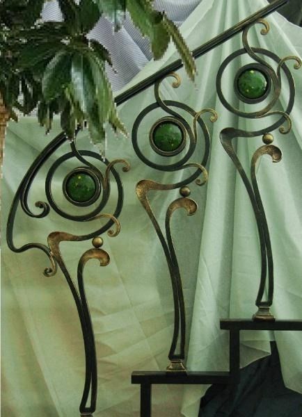 an iron sculpture with green glass eyes on it's head and arms, in front of a curtain