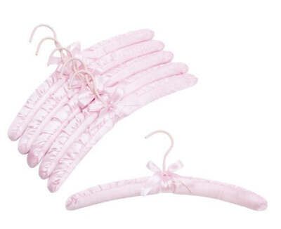 several pink hair clips with bows on them