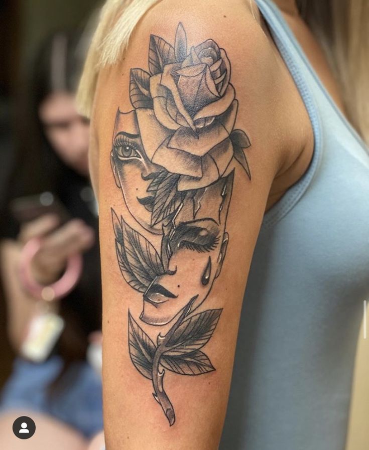 a woman with a rose tattoo on her arm