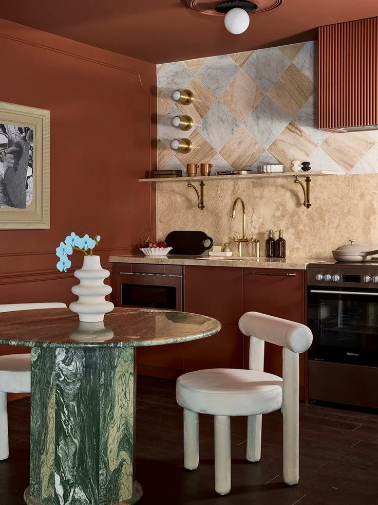 a kitchen area with a table, stove and oven in it's center island