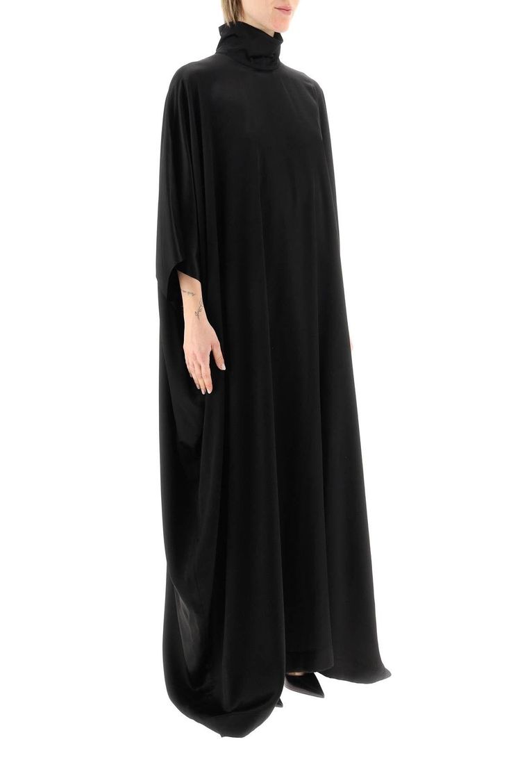 Long cape dress by Balenciaga crafted in viscose and cupro satin, featuring high neck, wide long kimono sleeves and rear zip fastening. The model is 177 cm tall and wears a size 1. Composition: 58% Viscose 42% Cu Silk Cape Kaftan, Elegant Draped Kaftan With Draped Sleeves, Elegant Oversized Abaya, Oversized Silk Elegant Dresses, Oversized Elegant Silk Dress, Silk Maxi Kaftan For Evening, Evening Kaftan With Draped Cape Sleeves, Silk Maxi Length Kaftan For Evening, Long Satin Kaftan For Evening