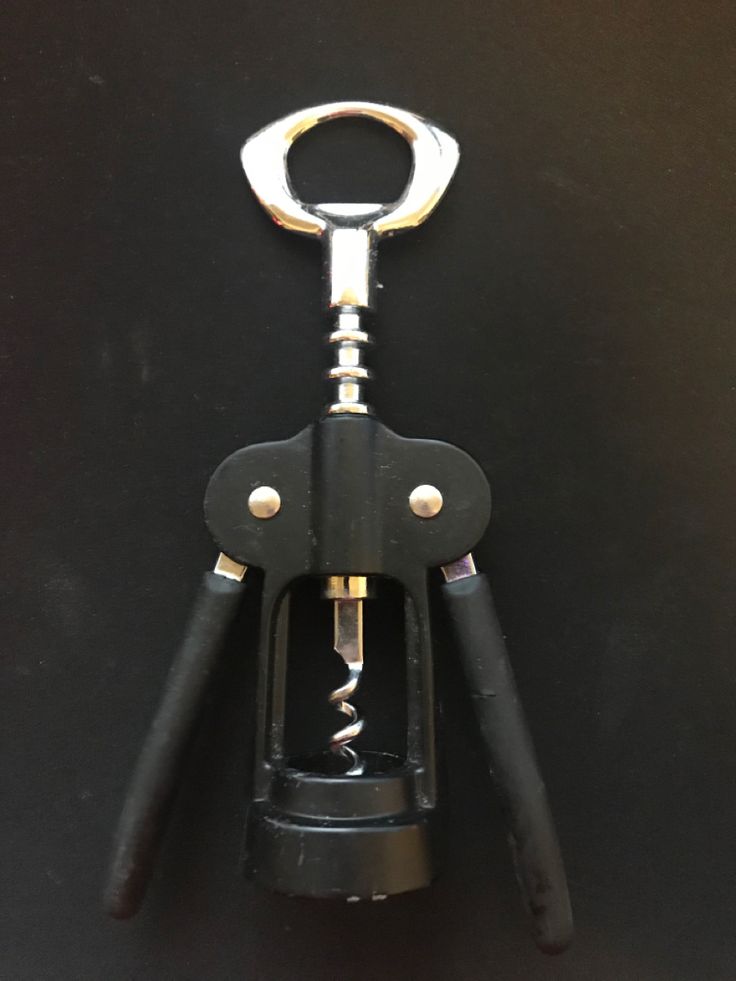 a pair of pliers with black handles and gold accents on the handle are open