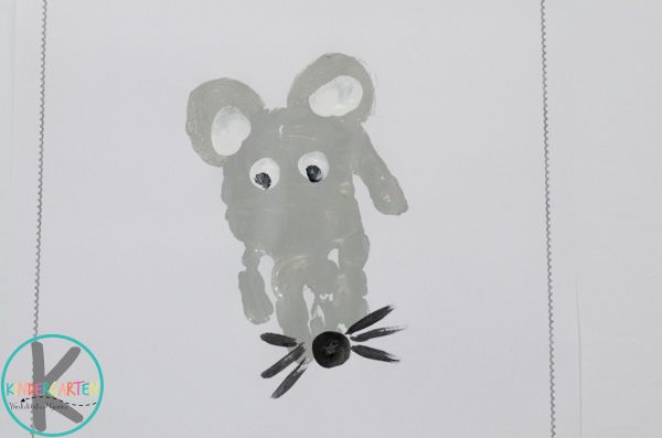 an animal made out of plastic on top of a sheet of paper with spider legs