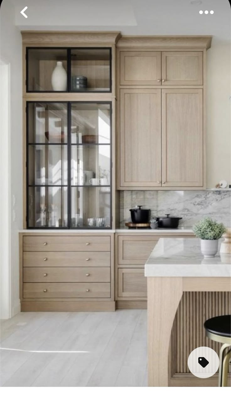 a kitchen with wooden cabinets and marble counter tops