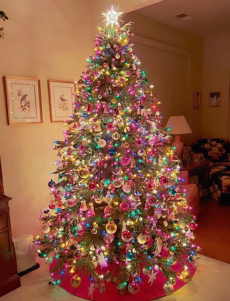 a brightly lit christmas tree in a living room