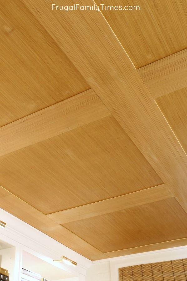 a kitchen with wooden ceiling and white walls