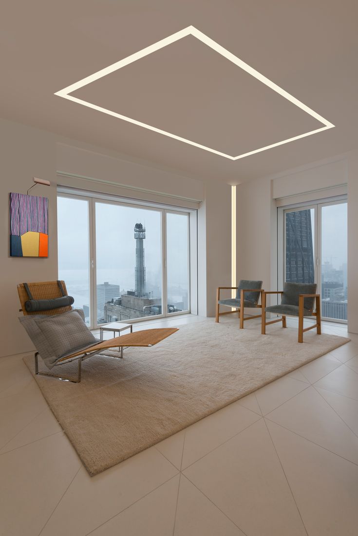 an empty living room with large windows overlooking the city