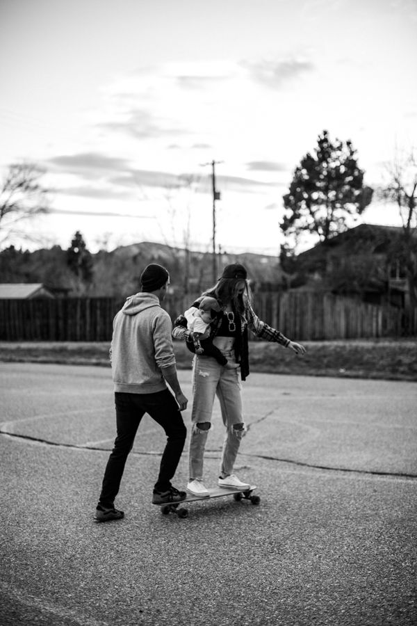 two people are skateboarding down the street