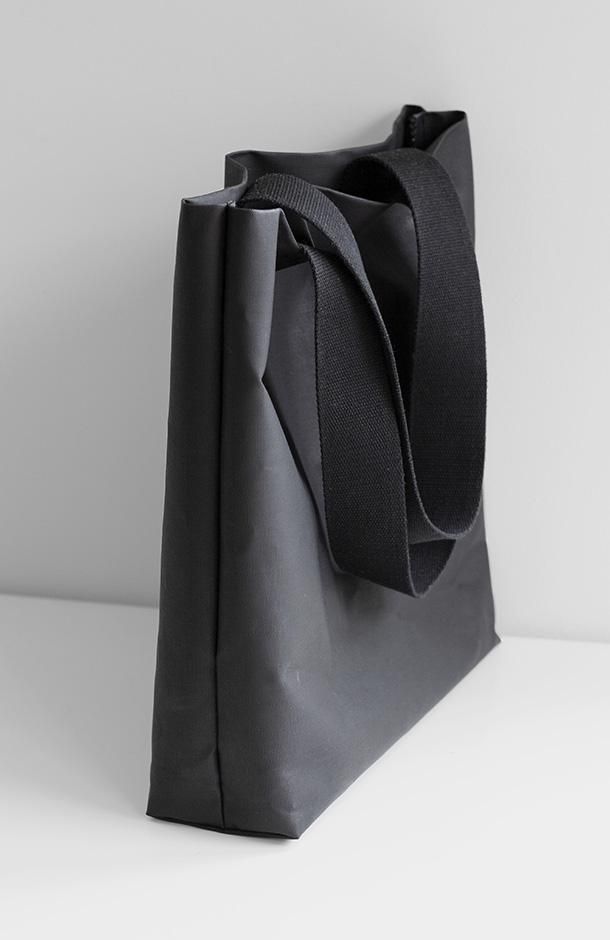 Color: BlackFabric: Cotton, PolyesterCare: Do not wash Canvas tote bag. Water resistant. Lightweight 5oz (140g). High: 15' (40cm). Wide: 17' (43cm). Depth at base: 4' (10cm). Handle drop lenght: 23.5' (60cm) wide: 2' (5cm). Made in USA. Modern Black Canvas Bag With Large Capacity, Modern Large Capacity Black Canvas Bag, Modern Black Canvas Bag With Adjustable Strap, Modern Black Canvas Bag, Black Canvas Tote Bag With Reinforced Handles, Black Canvas Bag With Reinforced Handles, Black Canvas Bag With Reinforced Handles For Everyday Use, Black Tote Shoulder Bag With Reinforced Handles, Black Canvas Bag With Reinforced Handles For Shopping