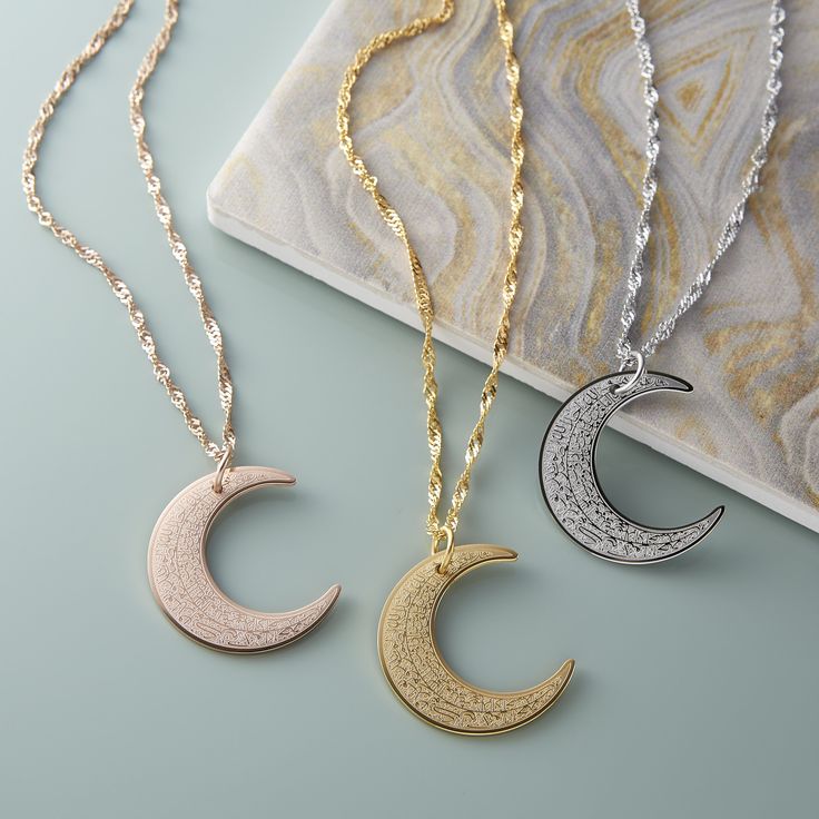 Item Description Engraved along the shape of the iconic crescent, this piece features the four surahs beginning with "Qul", to give you a piece that, like the moon, can provide light in times of darkness. Model is wearing her necklace at 16“. Materials & Warranty Necklace Length: 16 inch chain + 6 inch extension (22 inches total) | 41-56 CM Extensions are available here. Material: Premium Stainless Steel, dipped in real 18 Karat Gold Hypoallergenic | Sensitive Skin-Friendly Warranty: Lifetim 4 Qul, Moon Fashion, Islamic Jewelry, Crescent Necklace, Crescent Moon Necklace, Necklace Women, Elegant Accessories, Silver Pieces, Moon Pendant