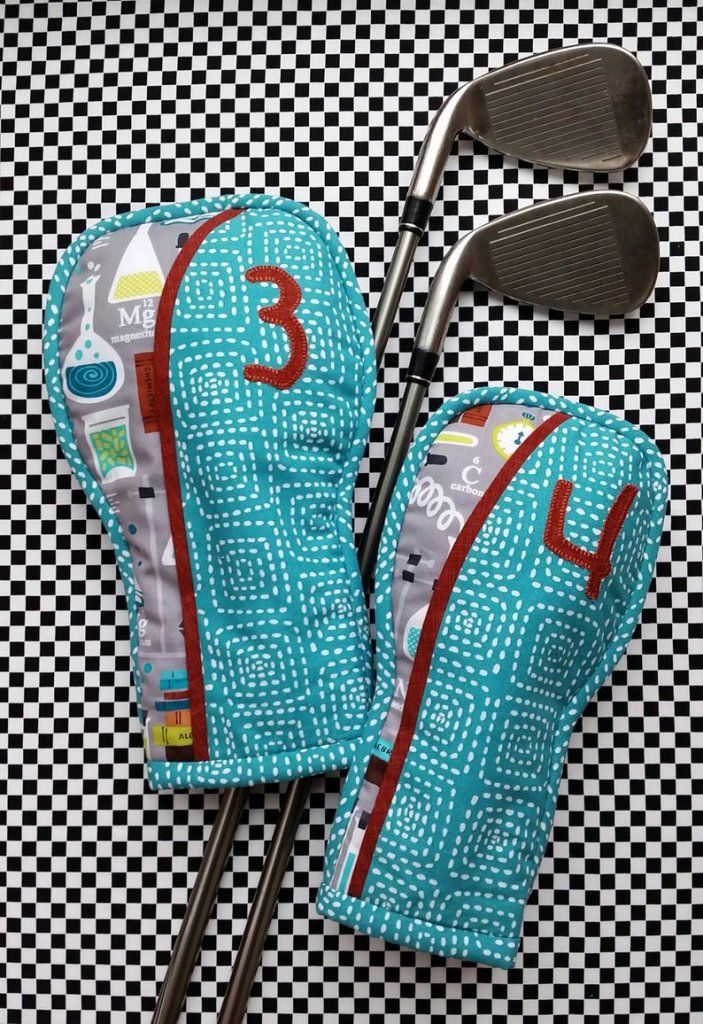 two golf clubs and driver's mitts on a checkered background