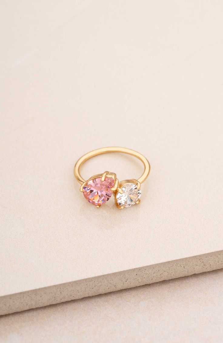 A mixed duo of cubic zirconia shimmers brilliantly atop this slender ring band plated in 18-karat gold. Cubic zirconia/18k-gold plate Imported Pink Gemstone Rings, Colorful Promise Rings, Couple Birthstone Ring, Gold And Pink Ring, Senior Ring, Eclectic Engagement Rings, Senior Rings, Pink Rings, Fun Rings