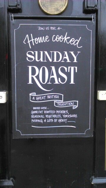 a chalkboard sign on the front door of a house cooked sunday roast restaurant in london