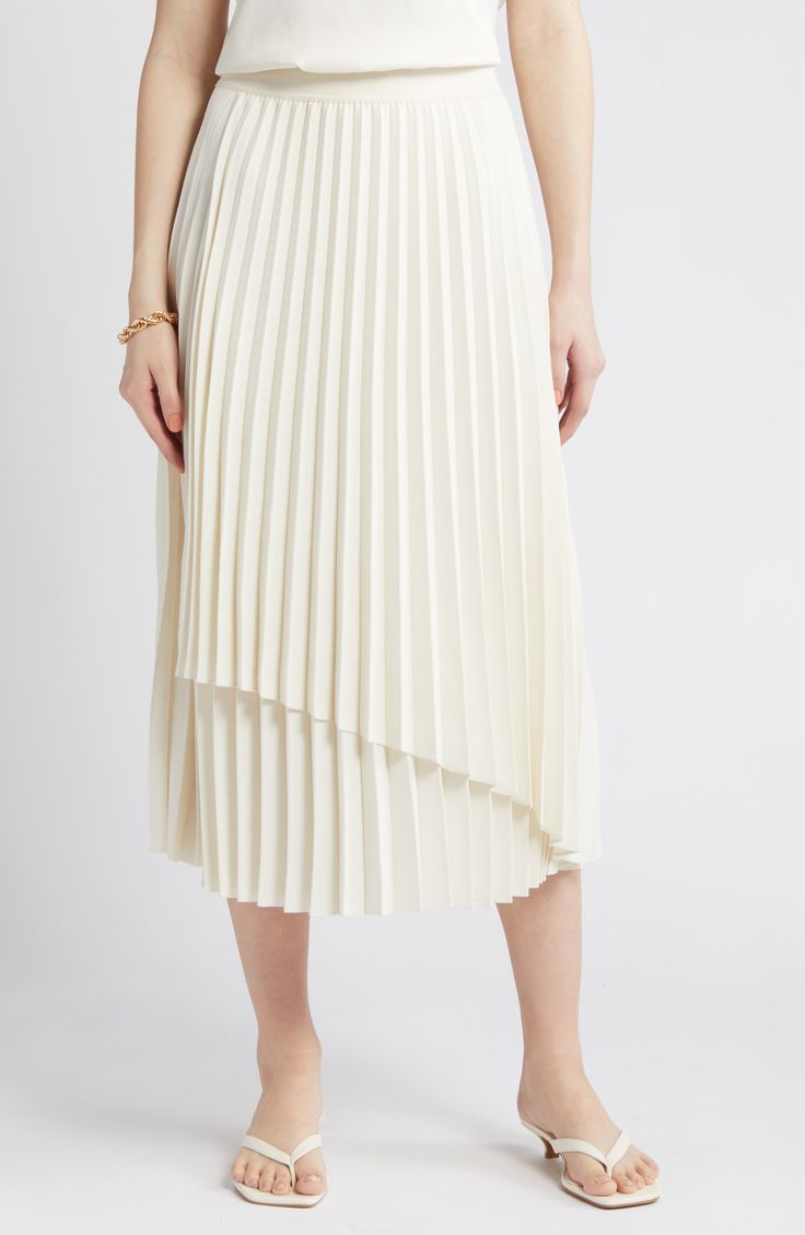 An elastic waist tops this flowy midi-length skirt accented with a layered design, asymmetric hem and easy-moving pleats. Elastic waist 100% polyester Dry clean Imported Chic Spring Midi-length Draped Skirt, White Asymmetrical Pleated Skirt For Summer, Flowy Asymmetrical Draped Skirt With Pleats, Asymmetrical Flowy Draped Pleated Skirt, White Midi-length Accordion Pleated Skirt, White Midi Length Accordion Pleated Skirt, Spring Flowy Draped Midi Skirt, White Flowy Pleated Midi Skirt, White Flowy Midi Draped Skirt