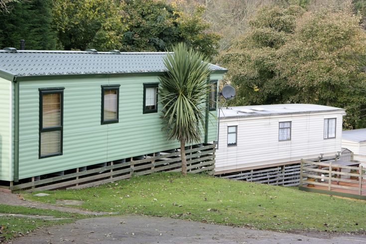 two mobile homes are parked next to each other