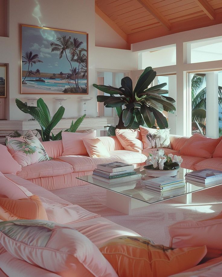 a living room filled with lots of pink furniture and large plants in the window sill