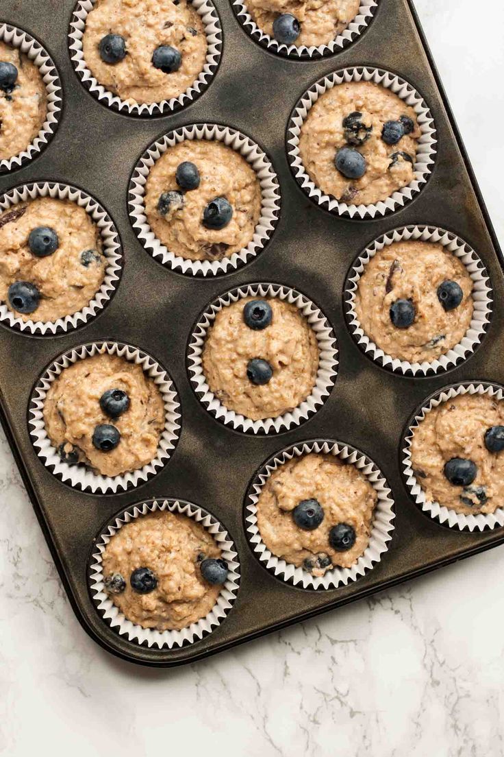 blueberry oatmeal muffins on a baking tray ready to be baked