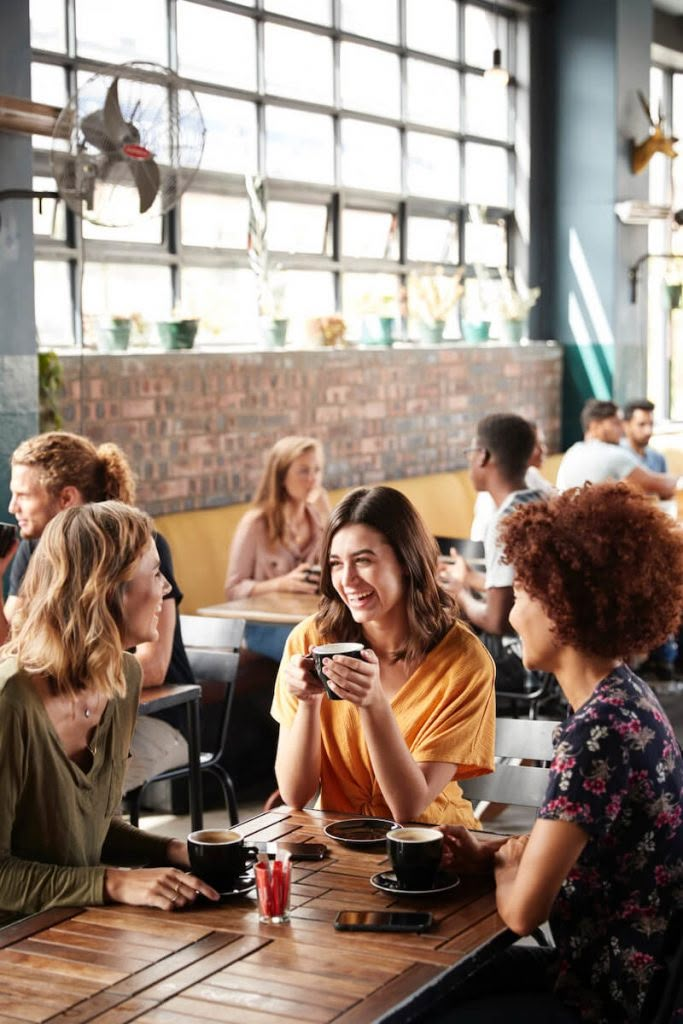 several people sitting at a table in a restaurant