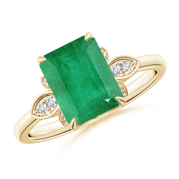 an emerald and diamond ring in yellow gold