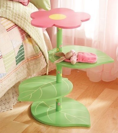 a child's bedroom with pink and green furniture, bedding and accessories on the floor