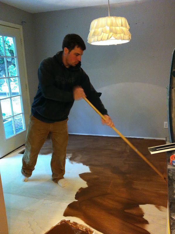 a man is cleaning the floor with a mop