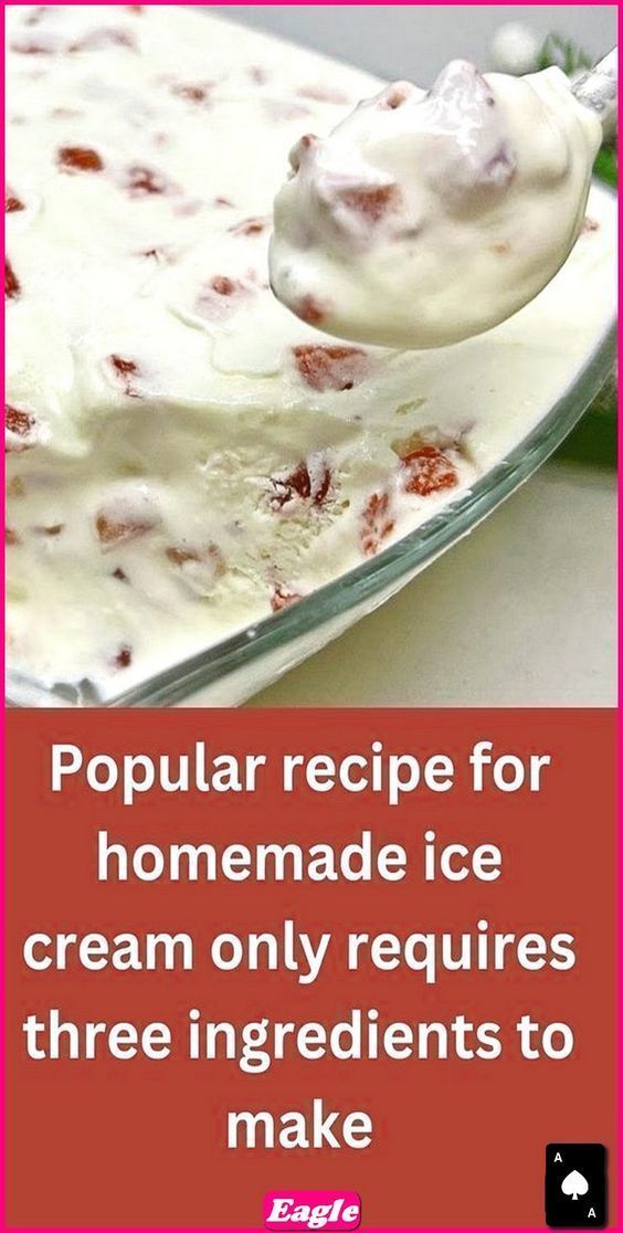 a spoon full of ice cream sitting on top of a white plate with strawberries