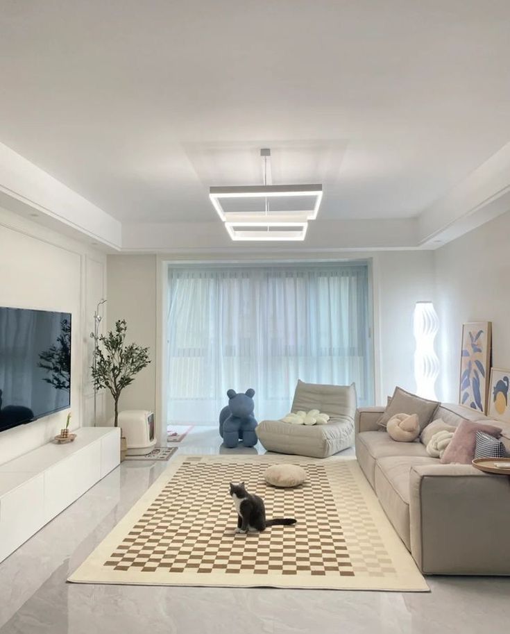 a living room filled with furniture and a flat screen tv mounted to the side of a wall