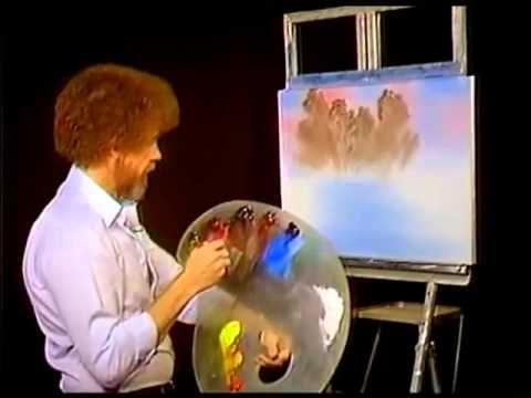 a man is painting on an easel with his hands