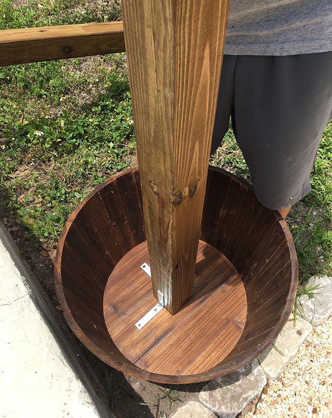 a person standing next to a wooden pole