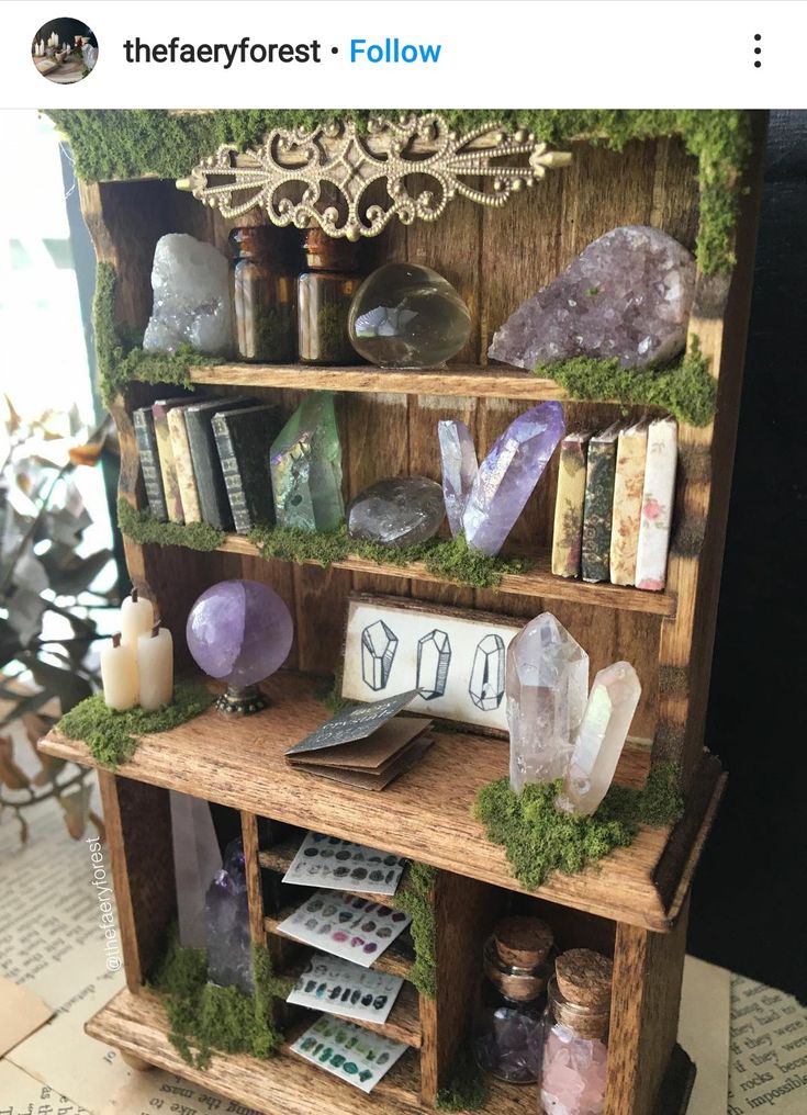 a wooden shelf filled with lots of rocks and crystals