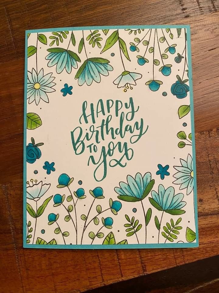 a birthday card with blue flowers and green leaves on the bottom, says happy birthday to you