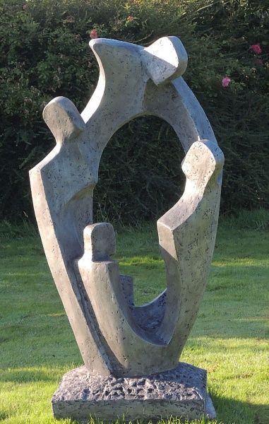 a sculpture sitting on top of a lush green field