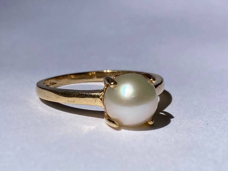 Beautiful single pearl ring in a claw mount from the late Art Deco era in 14K yellow gold. This beautiful pearl ring features a very pretty 6.6mm natural pearl mounted in a decorative yellow gold claw mount. The pearl is in excellent condition with lovely luster, and the prongs and ring shank are in mint condition. Ring size 5 1/2 and easily sized up or down several sizes. Ring sizing service available; please see sizing fees listed below. Please allow one week for sizing. One month layaway paym Pearl Rings In Gold, Pearl Ring Design, Pearl Rings Vintage, Late Art, Gold Pearl Ring, Single Pearl, Ring Shank, Gold Solitaire Ring, Right Hand Rings