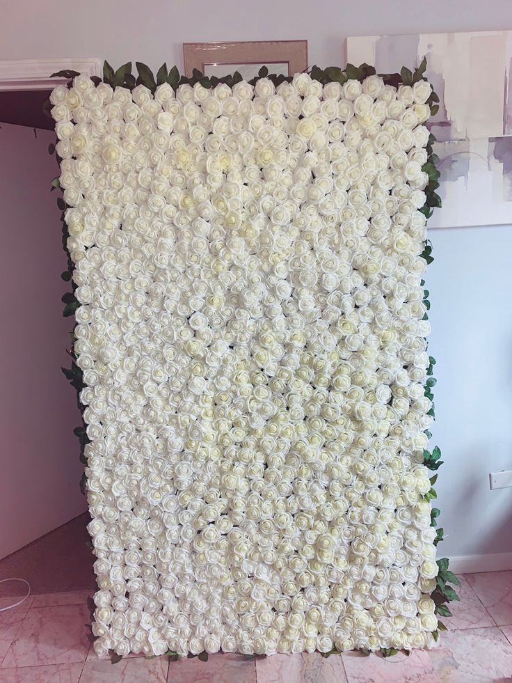 a large white flower covered wall in a room