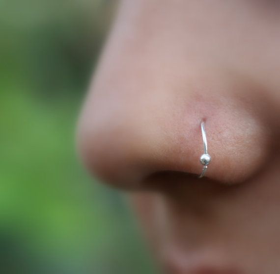 a close up view of a nose piercing