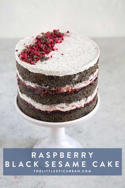 a cake with white and black frosting on a plate, topped with cranberry sprinkles