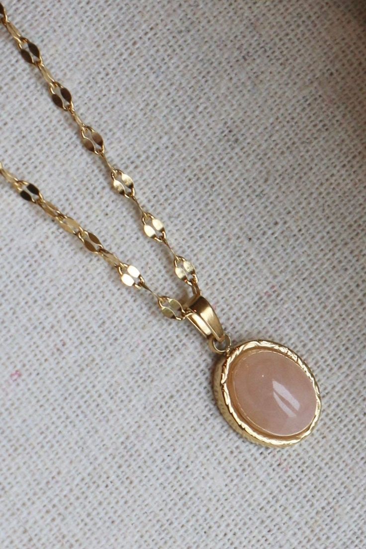 This Rose Quartz Necklace is a delicate, timeless addition to any jewellery collection. Designed with a gold petal chain to catch the light. * Polished gold plated finish, that won’t fade or tarnish * Chain is 45cm with a 5cm extension, pendant is 10x8mm * Hypoallergenic, hard-wearing steel base for sensitive skin. Rose Quartz Gold Jewelry, Rose Gold Oval Gold-plated Necklace, Rose Gold Tarnish Resistant Oval Pendant Necklace, Feminine Gold Round Pendant Jewelry, Delicate Rose Gold Pendant Chain Necklace, Delicate Rose Gold Plated Chain Necklace, Delicate Rose Gold-plated Chain Necklace, Feminine Gold Charm Necklace With Clavicle Chain, Feminine Gold Charm Necklace With Delicate Chain