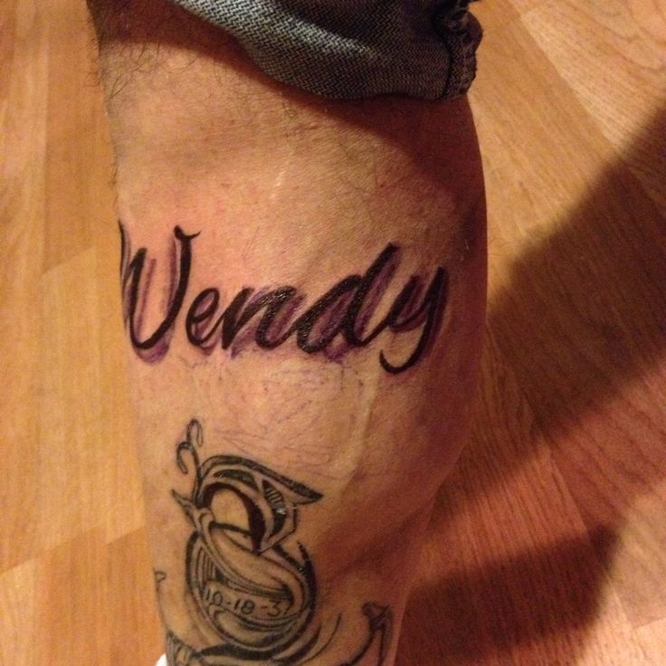 a close up of a person's leg with tattoos on it and the word wendy written in cursive writing