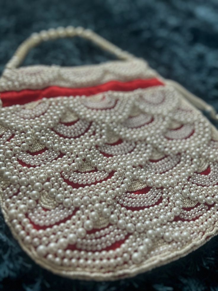 Red evening bag with elegant beadwork; perfect for weddings, parties and special occasions. Rectangular Beaded Potli Bag For Evening, Evening Rectangular Beaded Potli Bag, Festival Embellished Clutch Evening Bag, Embellished Clutch Evening Bag For Festivals, Red Shoulder Bag For Party And Festivals, Festive Beaded Rectangular Shoulder Bag, Traditional Beaded Clutch Bag, Traditional Evening Shoulder Bag With Pearl Handle, Elegant Beaded Potli Bag For Evening