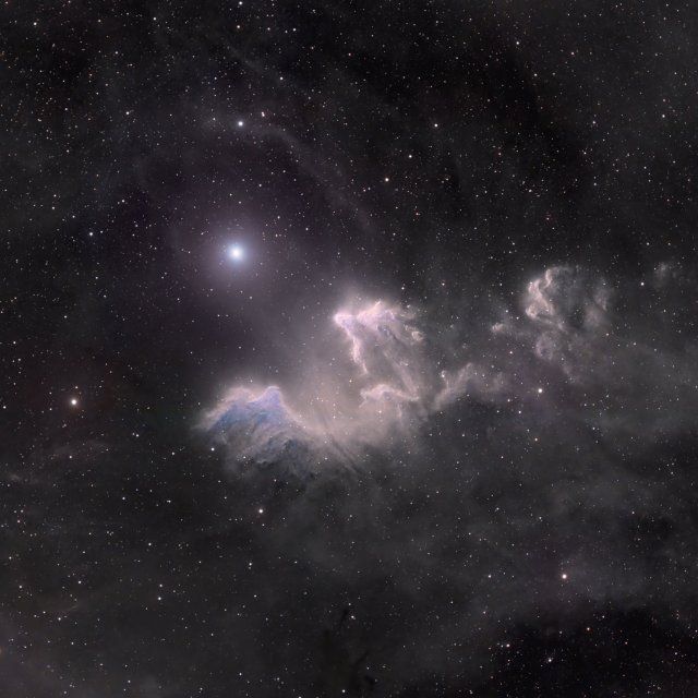 an image of the stars in the night sky with clouds and bright light shining on them