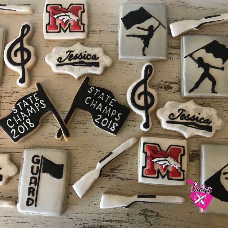 decorated cookies are arranged in the shape of musical instruments and music staffs, on a table