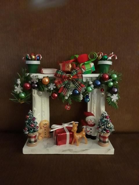 a christmas fireplace with presents and decorations