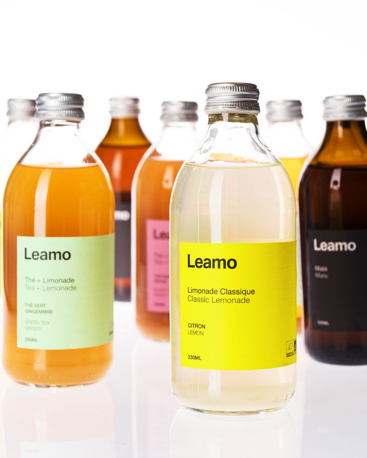 several bottles of liquid sitting next to each other on a white surface with the words leano printed on them