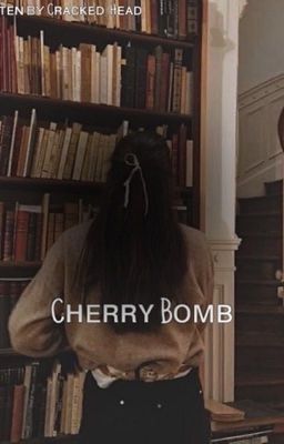 a woman standing in front of a bookshelf with her back to the camera