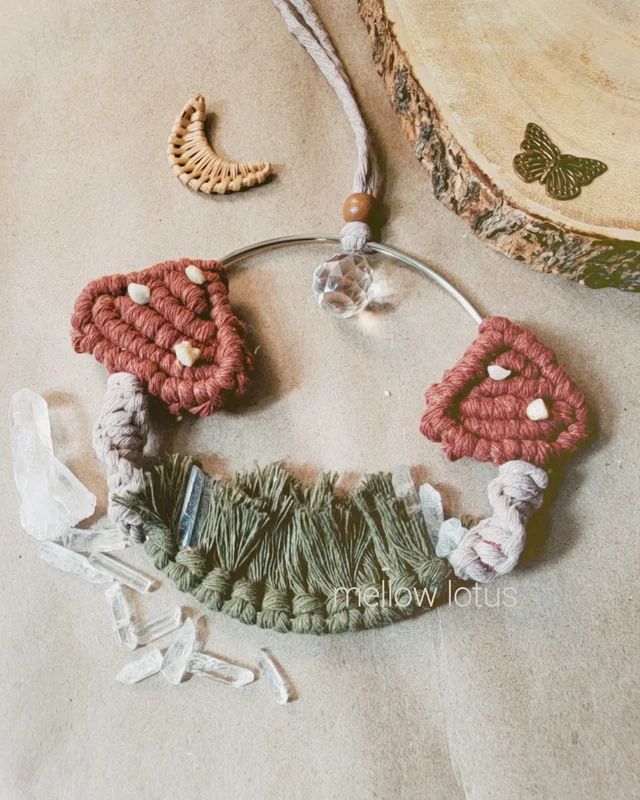 a close up of a necklace on a table with beads and other items around it