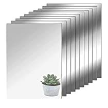 a set of six mirrors with a potted plant in the middle one on each side