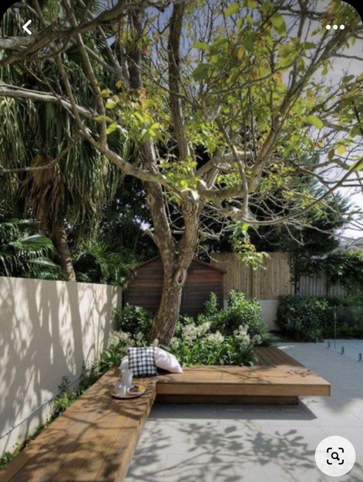 a wooden bench sitting in the middle of a garden