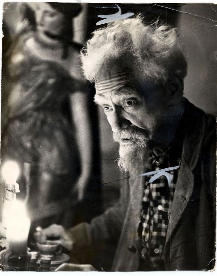 an old black and white photo of a man in front of a mannequin