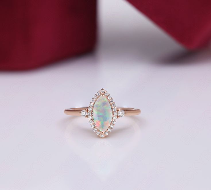 BeckyB Jewelry offers fine jewelry in solid gold and gold-plated 925 sterling silver RG8895 Metal type - 925 sterling silver Main Gemstone  - Opal  Gemstone Shape:-  Marquise Gemstone Size:- 10X5 mm Gemstone Wt - 1.24 Carats Side Stone- Moissanite Stamp - 925 Realization - Typical Handmade Occasions - engagement, wedding, birthday, anniversary, Easter gift, etc. We can make this particular ring with all types of semiprecious and precious gemstones [as per customer request]  We offer free domesti Marquise Halo Ring For Gift, Marquise Halo Design Ring For Gift, Marquise Halo Design Ring As Gift, Marquise Cluster Ring With Halo Setting For Gift, Marquise Cut Halo Ring Fine Jewelry Gift, Marquise Cut Halo Ring As Gift, Marquise Cut Halo Ring Fine Jewelry, Gift Jewelry With Halo And Marquise Cut, Fine Jewelry Marquise Halo Ring Gift