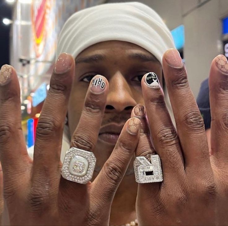 a man with two rings on his fingers and one ring in front of his face